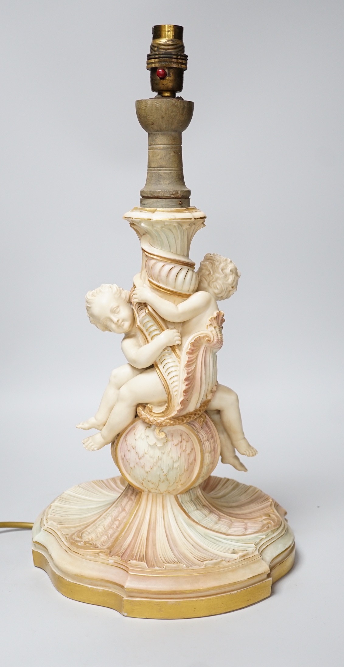 A large Royal Worcester blush ivory cherub lamp base, 40cm not including light fitting